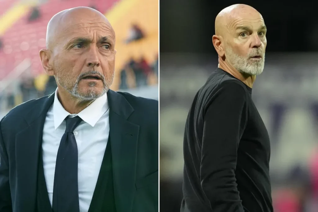 Due uomini calvi in primo piano: a sinistra in abito scuro con cravatta, a destra in maglione nero, con sfondo sfocato da sta